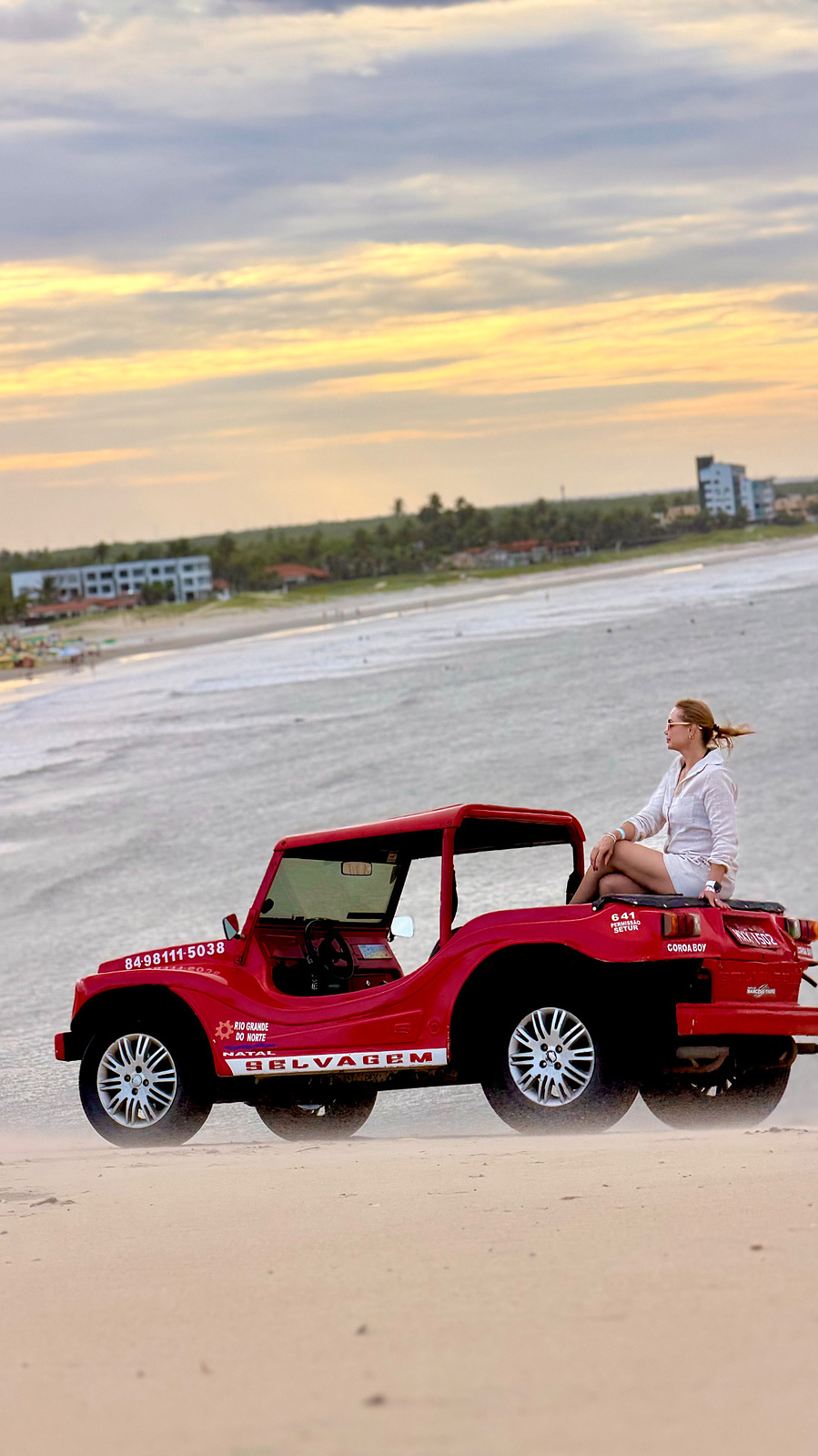 Buggy vermelho na praia no fim da tarde